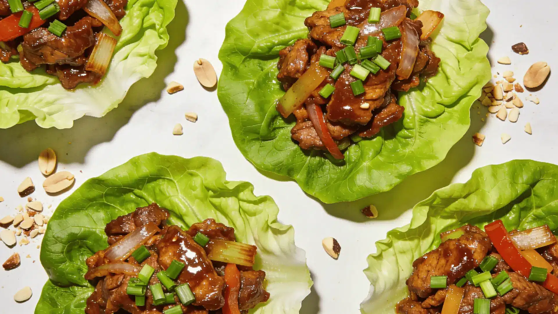 wraps filled with a savory mixture of ground meat, vegetables, and sauce, arranged on a white plate