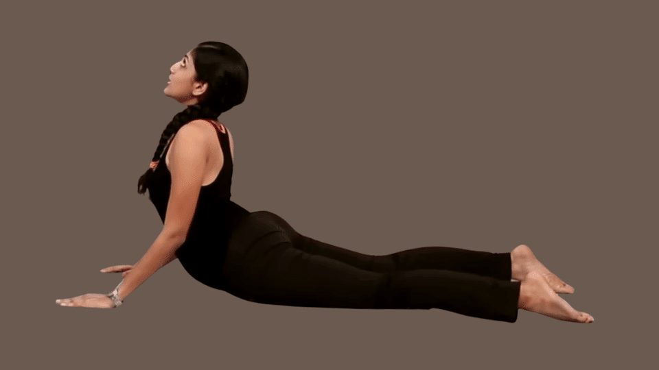 a woman doing adho mukha svanasana as a part of the surya namaskar series