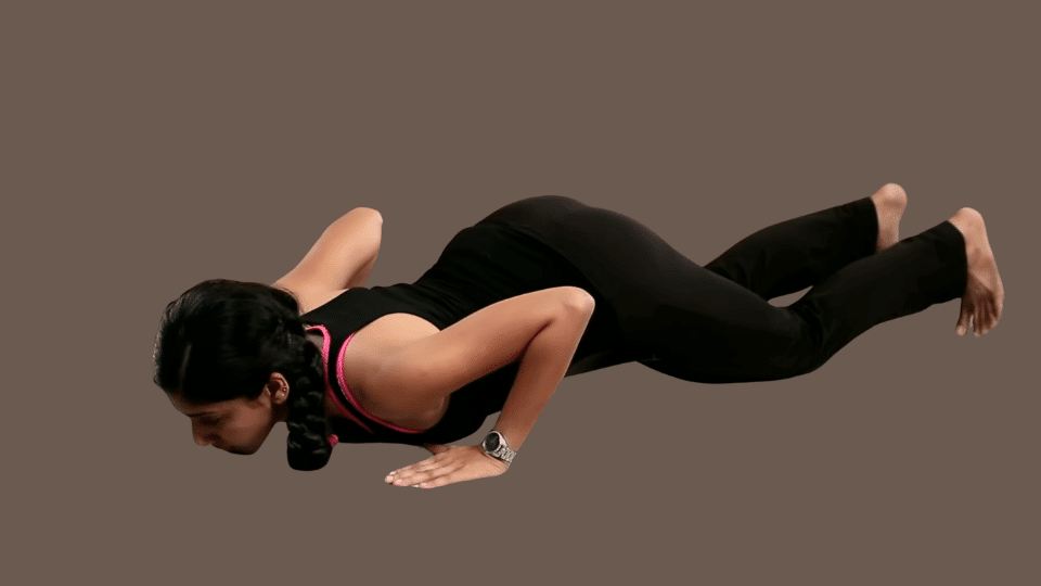 a woman doing ashtanga namaskara as a part of the surya namaskar series