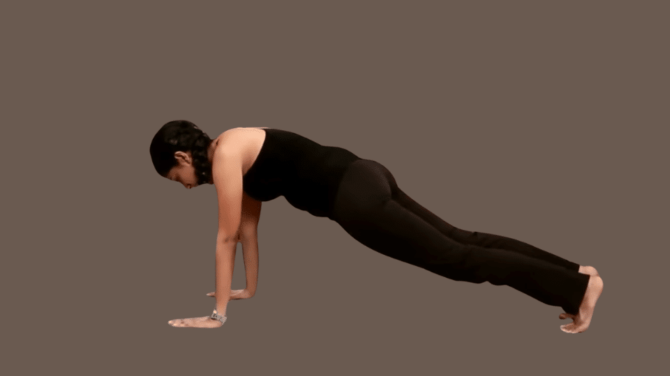 a woman doing dandasana as a part of the surya namaskar series