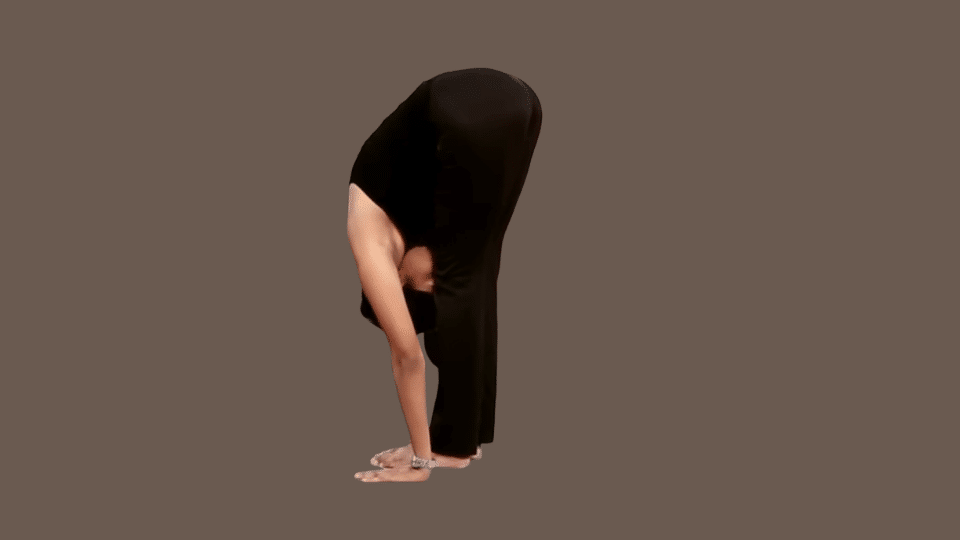 a woman doing hasta uttanasana as a part of the surya namaskar series