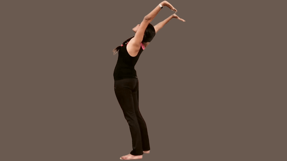 a woman doing hasta uttanasana as a part of the surya namaskar series