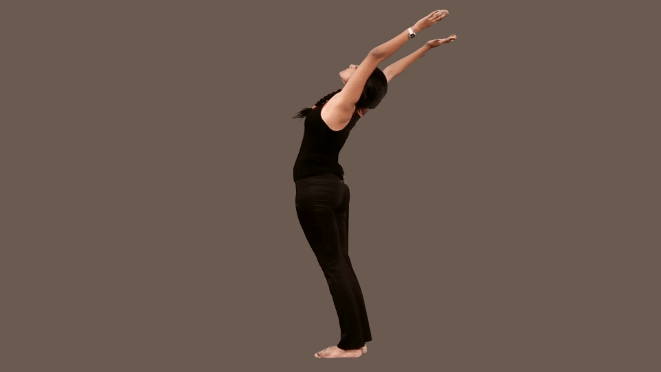a woman doing pranamasana as a part of the surya namaskar series