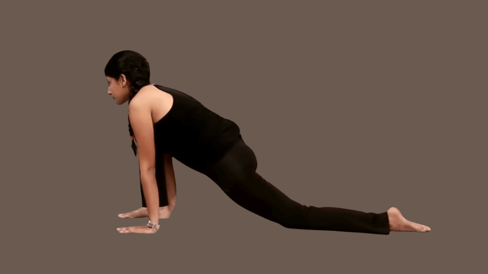a woman doing uttanasana as a part of the surya namaskar series (1)