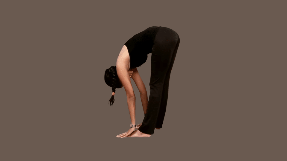 a woman doing uttanasana as a part of the surya namaskar series