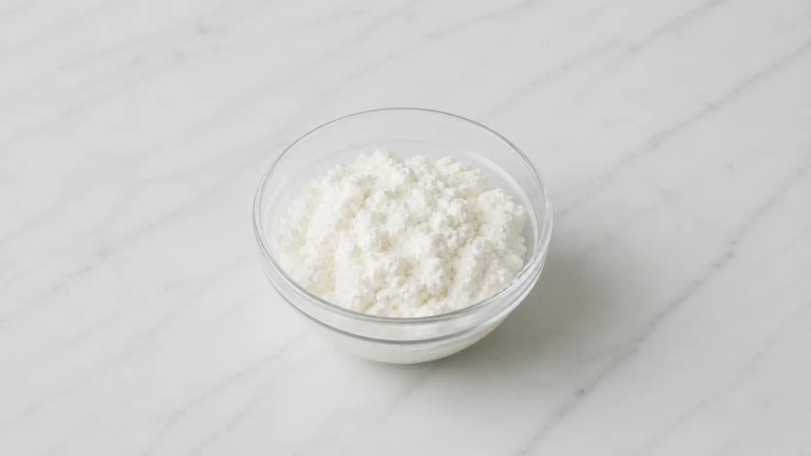 bowl of cottage cheese on marble surface with soft natural lighting