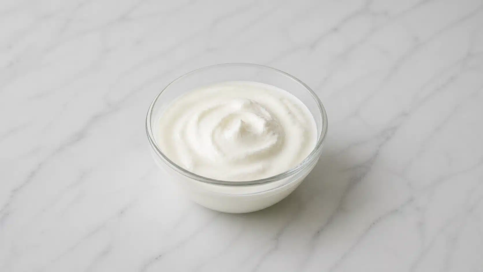 bowl of greek yogurt on marble surface with smooth creamy texture