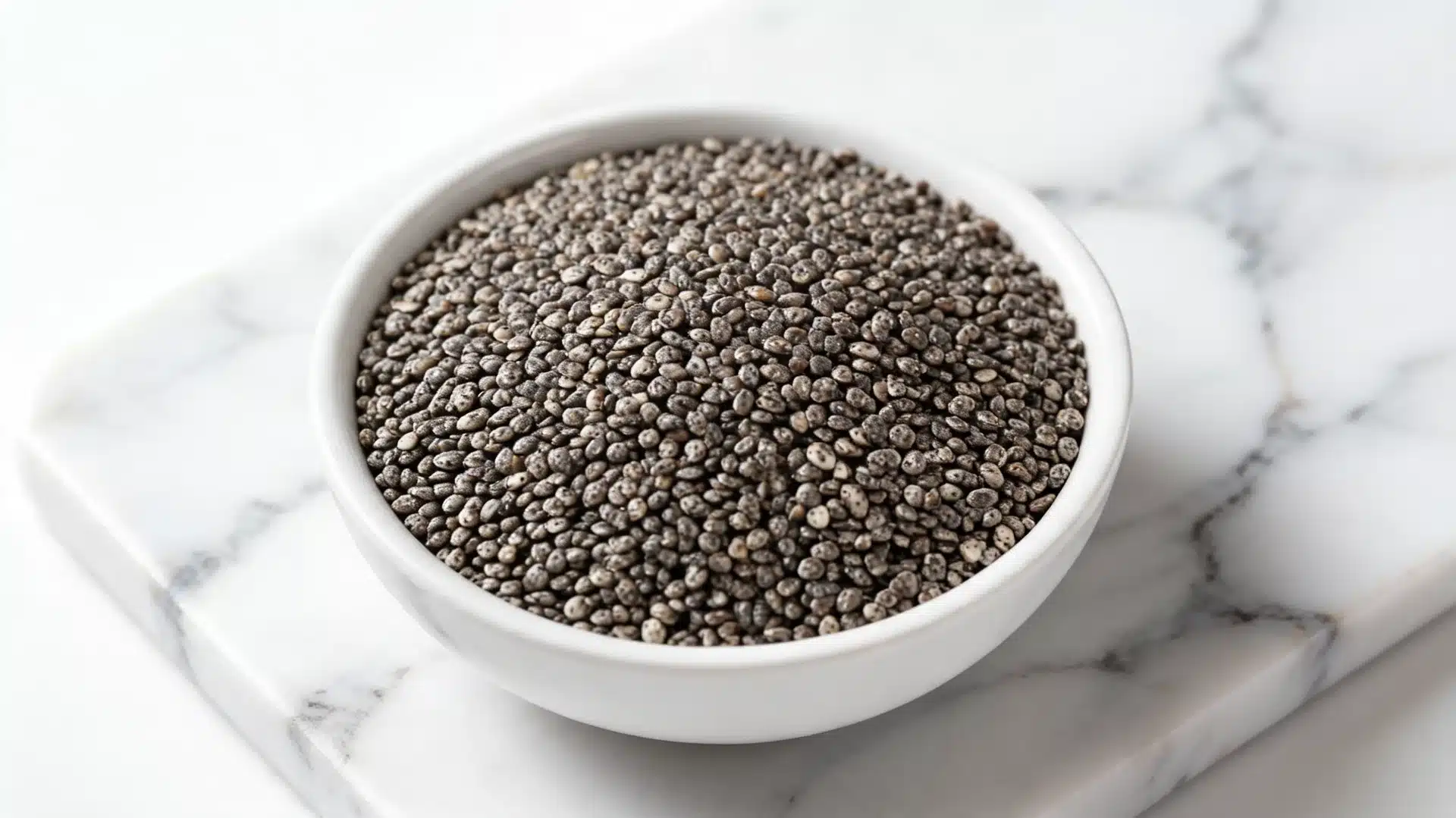 chia seeds in ceramic bowl on white marble surface with soft natural kitchen lighting