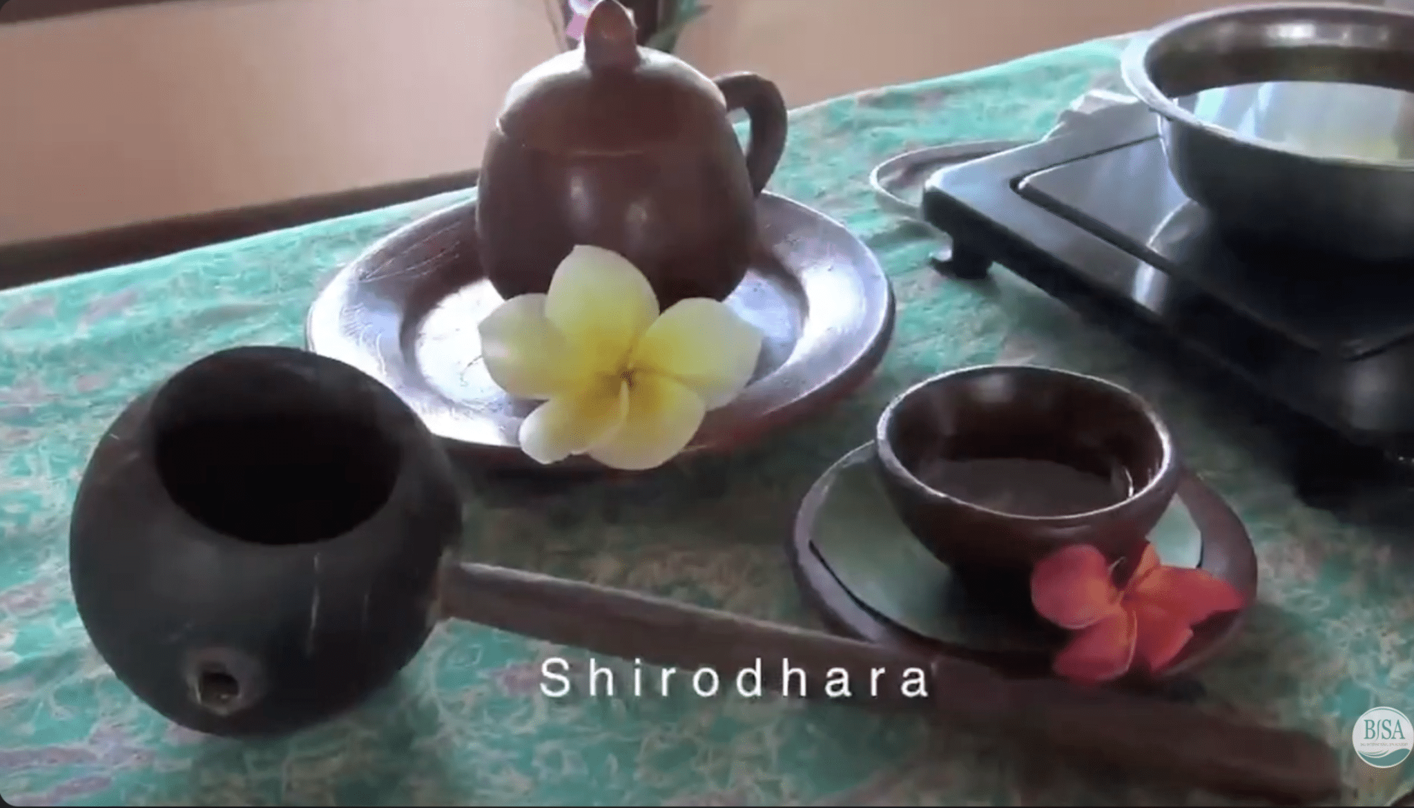 shirodhara oil tools and warm oil setup prepared on spa table before ayurvedic treatment
