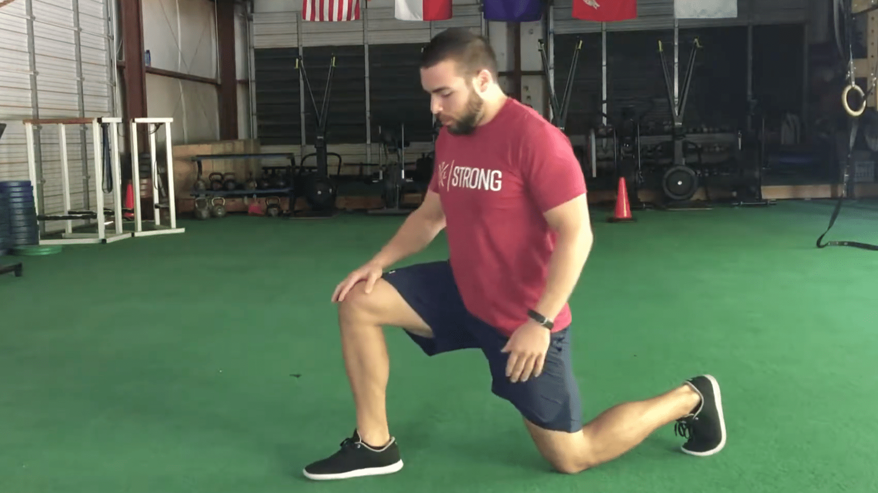 Side view of the starting setup with one foot forward and the back knee down.