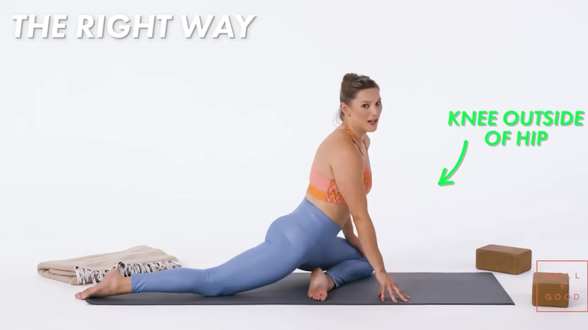 person placing the front knee outside the hip line to set up pigeon pose safely