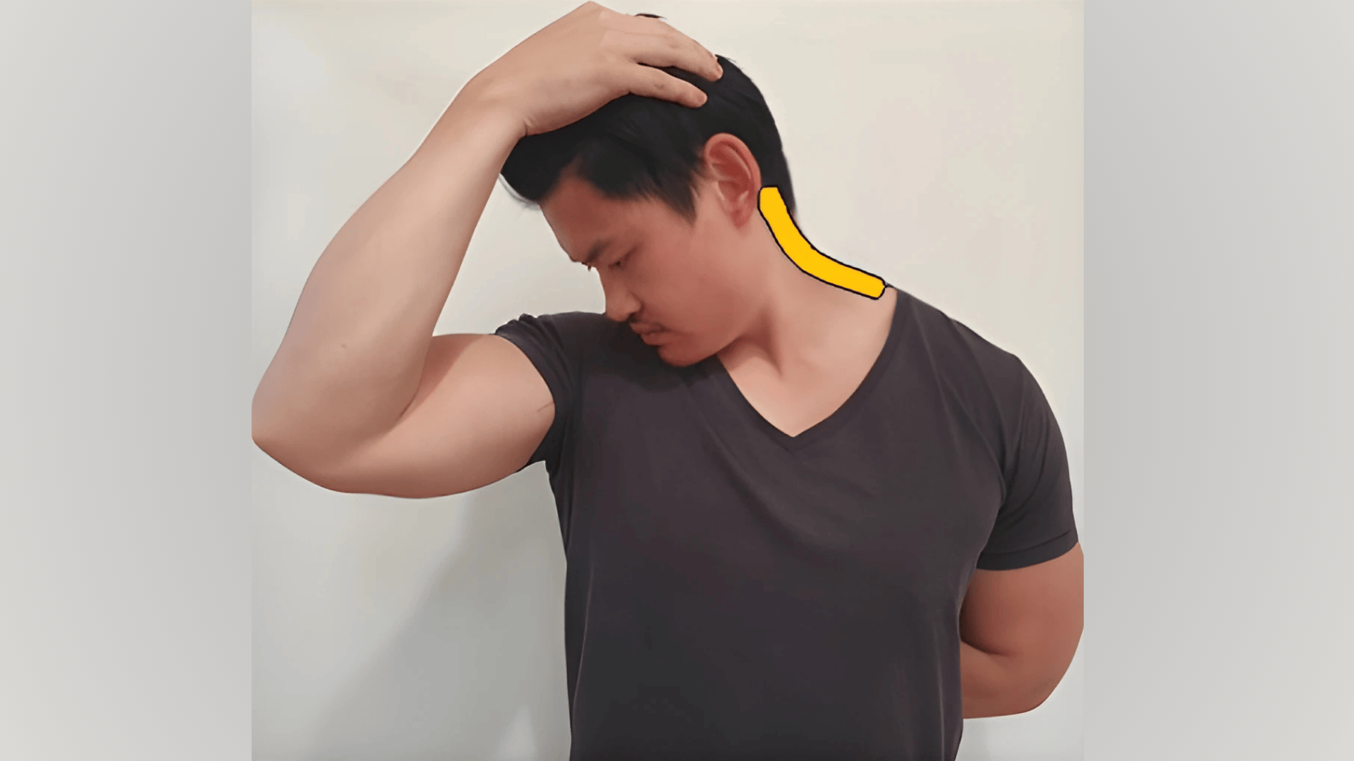 person gently pulling head diagonally down to stretch the levator scapulae at the back of the neck