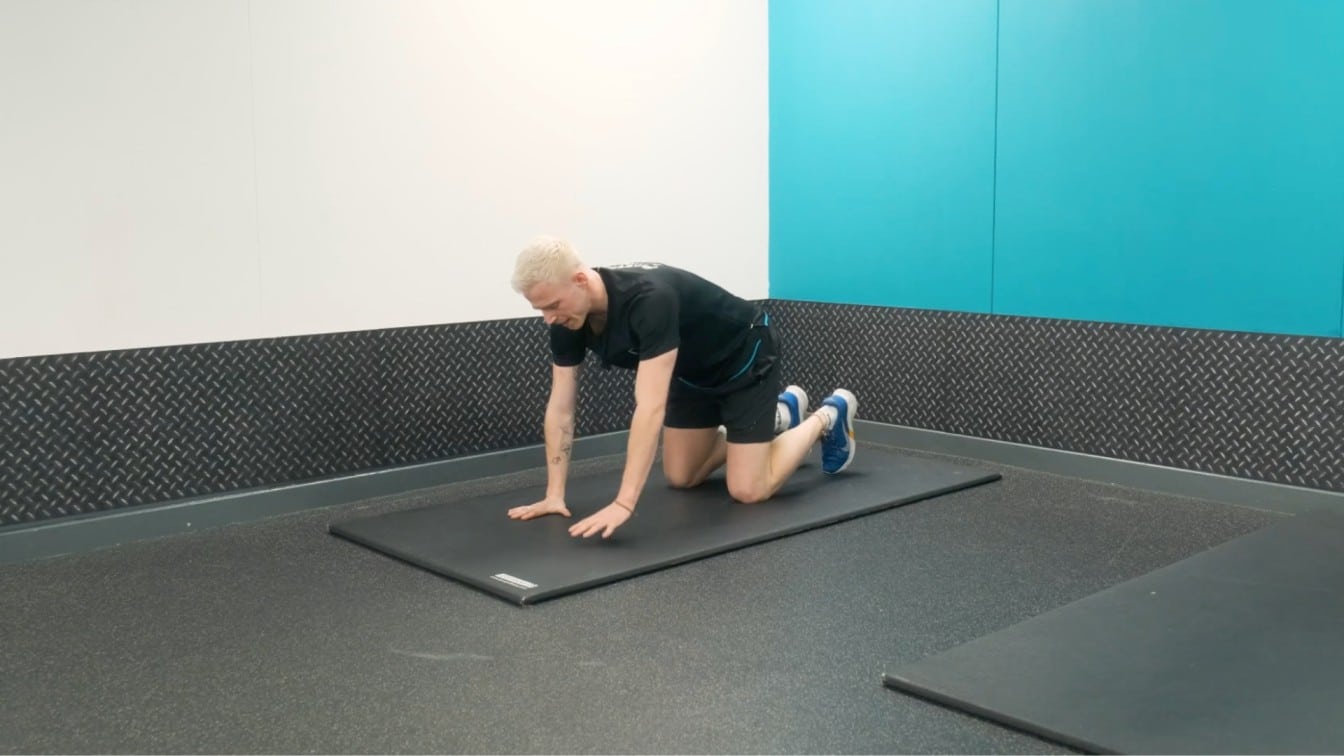 instructor starts in a hands-and-knees position.