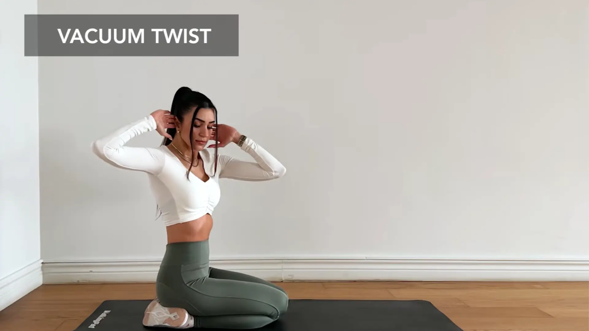beginner doing seated twist stomach vacuum with calm posture and gentle core control