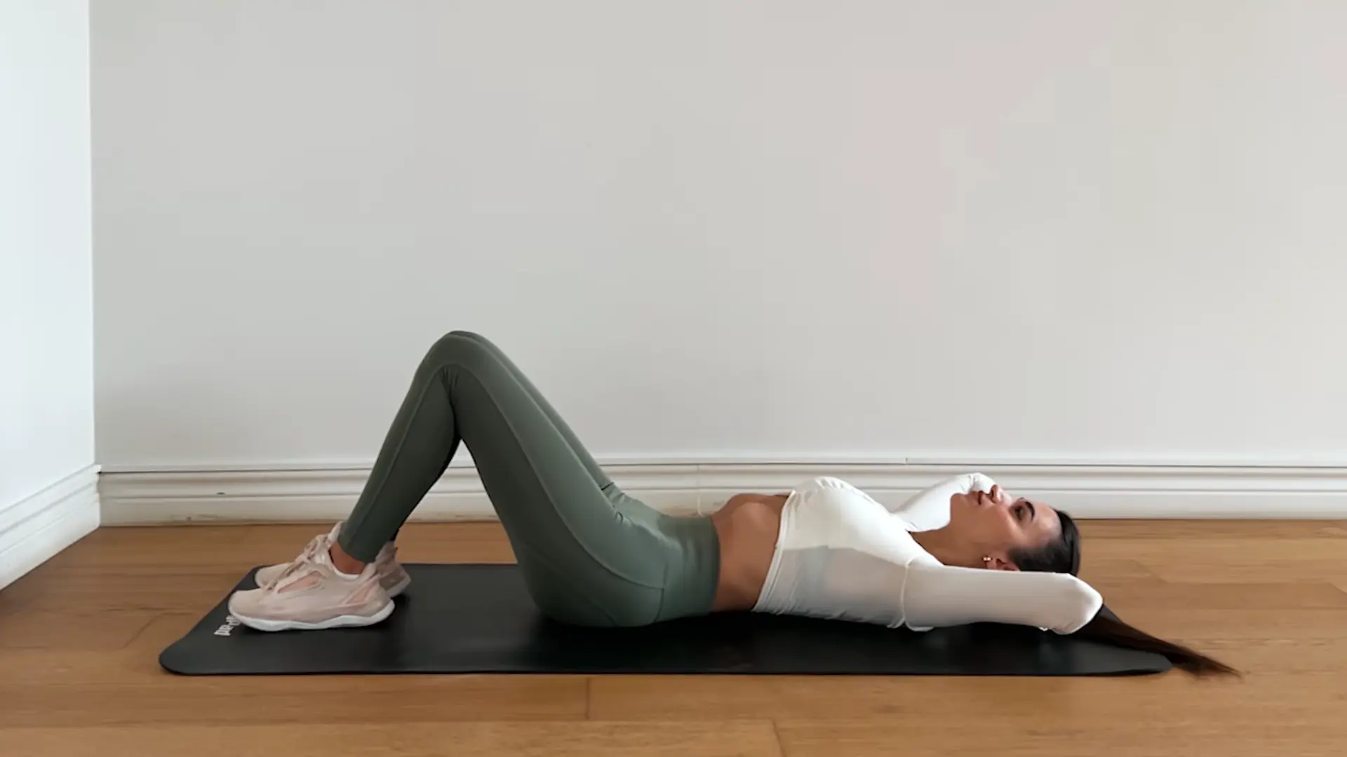 side view of beginner exhaling and pulling belly inward during stomach vacuum exercise