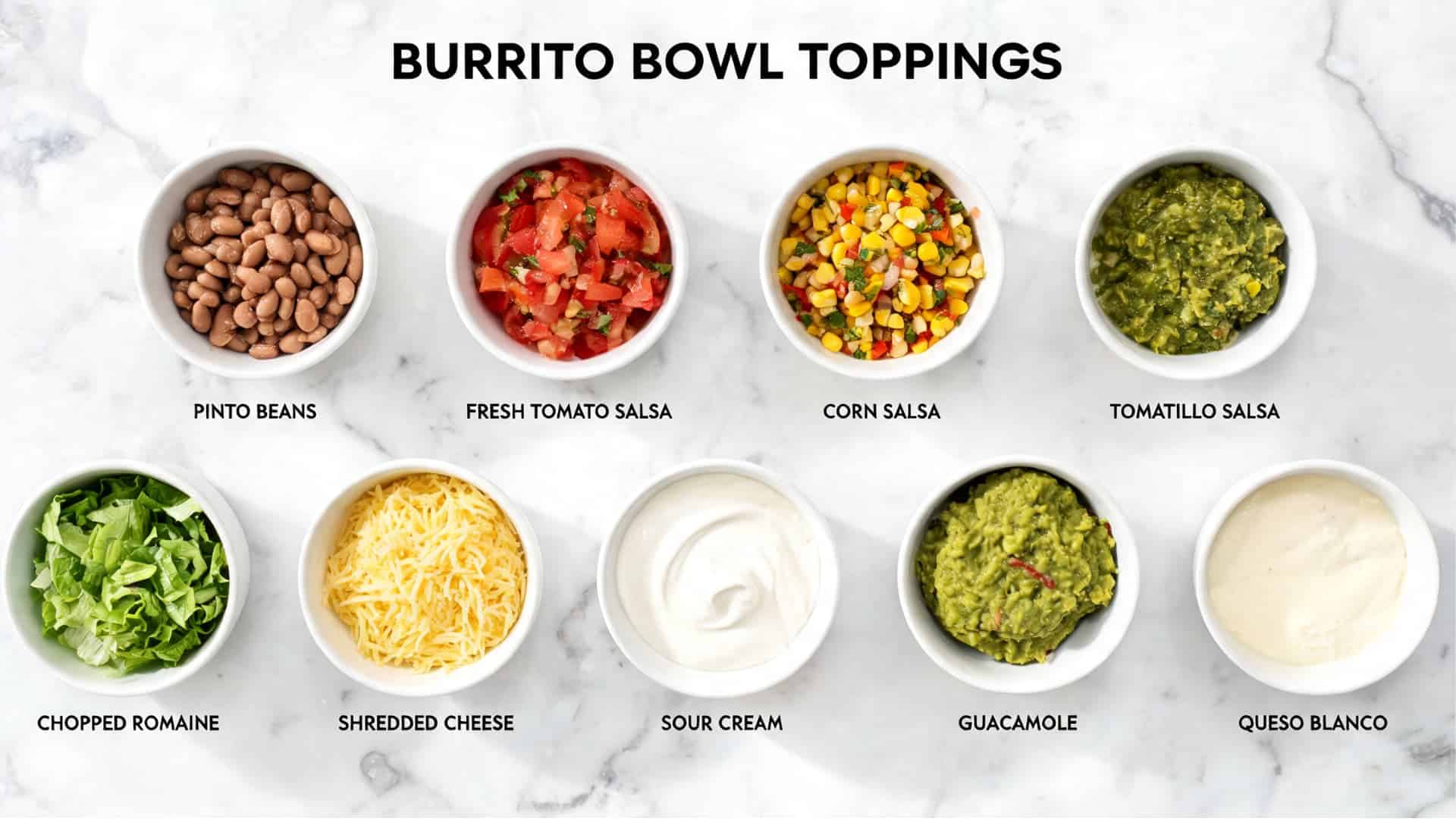 burrito bowl toppings with pinto beans salsas cheese sour cream guacamole queso and romaine on marble background