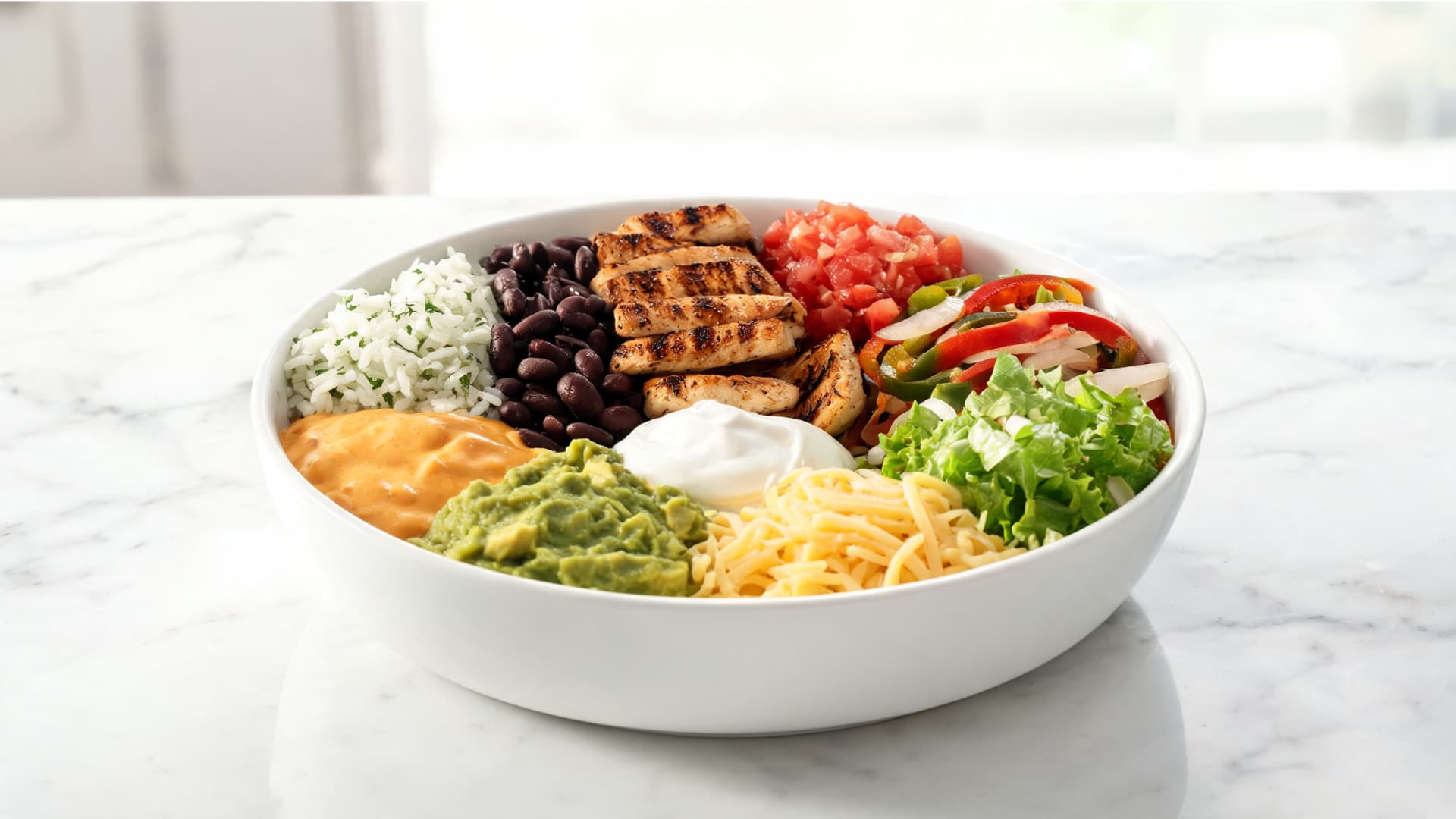 homemade burrito bowl with rice black beans grilled chicken salsa fajita veggies guacamole cheese and sour cream